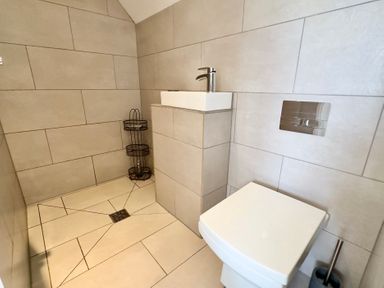 A bathroom with a toilet and sink at Kilcarreg in Rock near Wadebridge