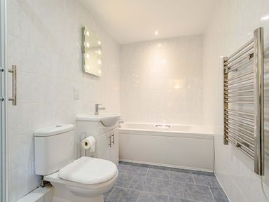 A bathroom with a toilet sink bathtub and towel radiator at The Bothy in Phocle Green near Ross-on-Wye