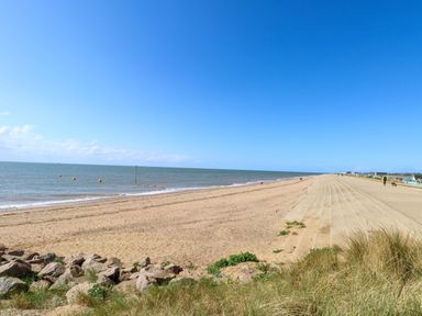 A beach with sand and sea at Fern Cottage in Heacham