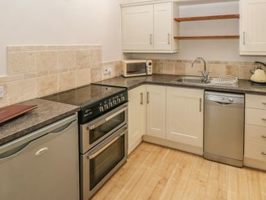 A kitchen with an oven dishwasher microwave sink and kettle at The Barn at Waunlippa Narberth