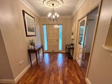 A hallway with a chandelier and a table at The Sanctuary in Killavullen near Mallow