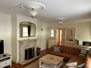 A living room with a sofa and a television at The Sanctuary in Killavullen near Mallow