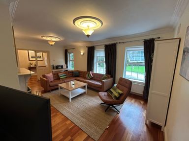 A living room with a sofa, coffee table, and armchair at The Sanctuary in Killavullen near Mallow