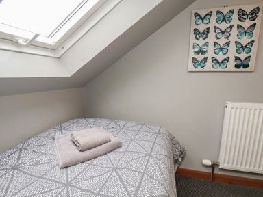 A bedroom with a bed and artwork at Fortunatus in Whitby