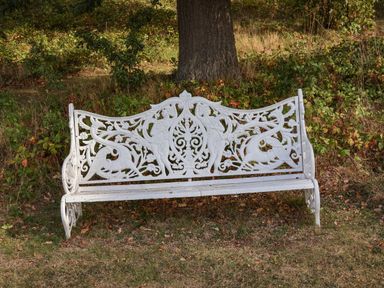 A white decorative bench in an outdoor setting at Snowdrop in Saltburn-by-the-Sea