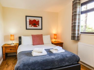 A bedroom with a bed and nightstands at Snowdrop in Saltburn-by-the-Sea