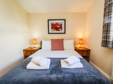 A bedroom with a bed and bedside tables at Snowdrop in Saltburn-by-the-Sea