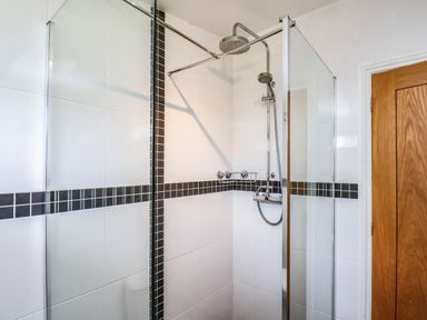 A shower with glass panels and controls at Snowdrop in Saltburn-by-the-Sea