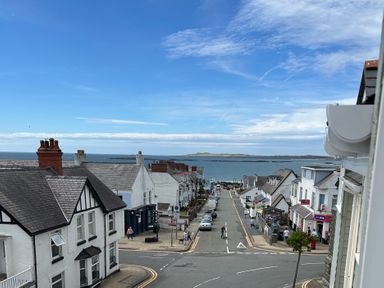 A view of a street and ocean at Maelog, 14 Tides Reach Rhosneigr
