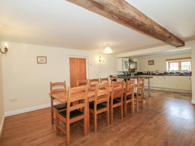 A dining room with a wooden table and chairs at The Wainhouse in Bockleton near Tenbury Wells