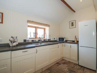A kitchen with sink and refrigerator at The Wainhouse in Bockleton near Tenbury Wells