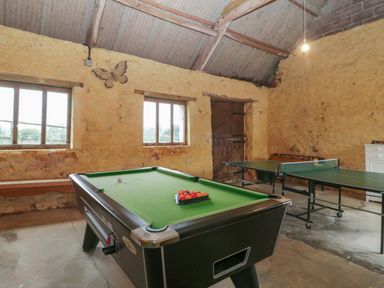 A game room with a pool table ping pong table and foosball table at Floras Barn in Crowcombe