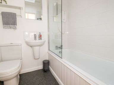 A bathroom with a toilet sink bathtub shower and towel at Slate Cottage Tredethy near Bodmin Moor