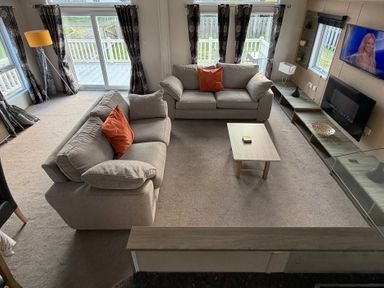 A living room with two sofas and a coffee table at Cheri in Southerness