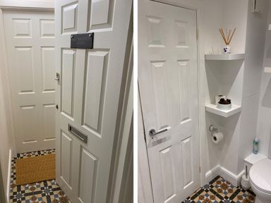 A hallway with two white doors and a patterned floor at 1 Beachtop Court Tenby