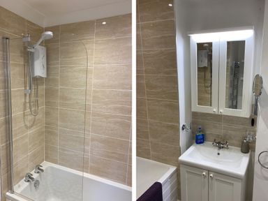 A bathroom with a bathtub shower combination and a sink with a mirror cabinet at 1 Beachtop Court in Tenby