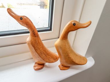 Two wooden duck figurines on a windowsill at Jasmine Cottage in Lesbury near Alnmouth