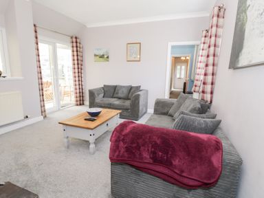 A living room with sofa and coffee table at Dyffryn Bach Glan-yr-afon near Corwen