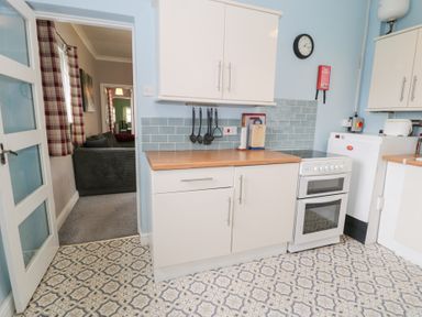 A kitchen with stove and units at Dyffryn Bach Glan-yr-afon near Corwen