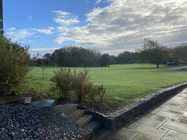 An outdoor view with grass and trees at Nyth Y Wennol in Abersoch