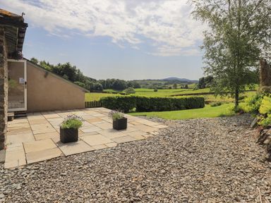 An outdoor area with a patio and view of the landscape at Acorn in Bowness-on-Windermere