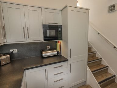 A kitchen with cabinets and appliances at Acorn in Bowness-on-Windermere