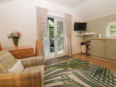 A living room with a sofa and table at Ash Lodge in Pennington near Ulverston