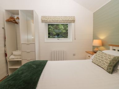 A bedroom with a bed and wardrobe at Ash Lodge Pennington near Ulverston