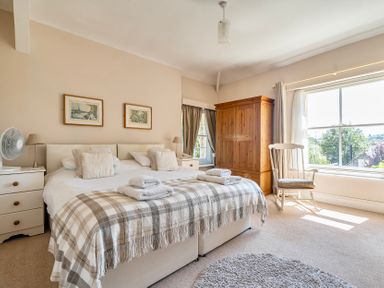A bedroom with a bed and wardrobe at East Wing in Crewkerne