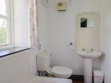 A bathroom with a sink and toilet at The Old Workshop in Knowstone