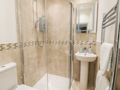A bathroom with a shower enclosure sink toilet and towel rack at Town Mill in Bewdley