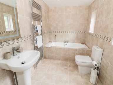 A bathroom with a bathtub sink toilet and towel rack at Town Mill in Bewdley