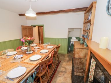 A dining room with a table set for a meal at Town Mill in Bewdley