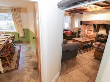A dining room with a table and chairs visible from a hallway at Town Mill Bewdley