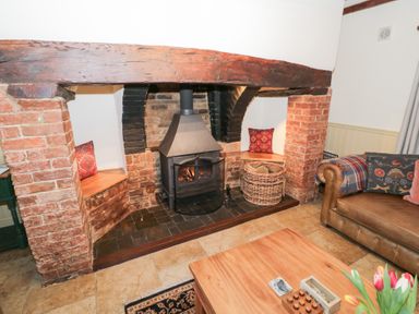 A living room with a fireplace and couch at Town Mill in Bewdley