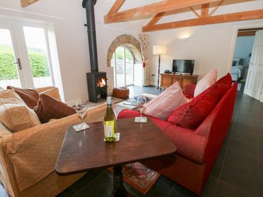A living room with a fireplace and sofa at Gallow Law Cottage in Bellingham