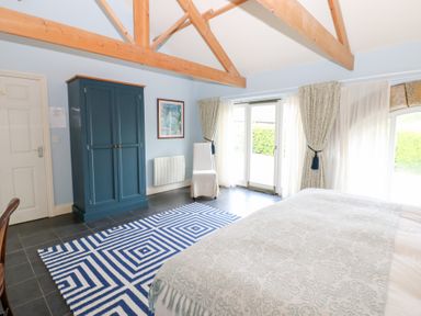 A bedroom with a bed and wardrobe at Gallow Law Cottage Bellingham