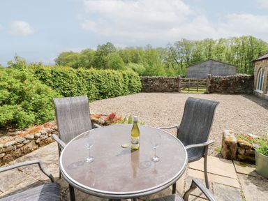 An outdoor area with a table and chairs at Gallow Law Cottage in Bellingham