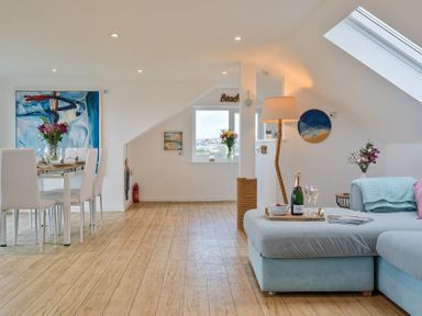 A living room with a table and chairs at Sunset View in Porth