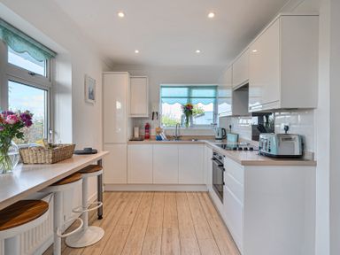 A kitchen with a sink and appliances at Sunset View in Porth