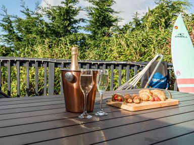 An outdoor area with champagne and snacks at Sunset View in Porth
