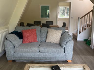 A living room featuring a sofa and dining area at Lodge 22, Bodmin Holiday Park, Cornwall, Lanivet