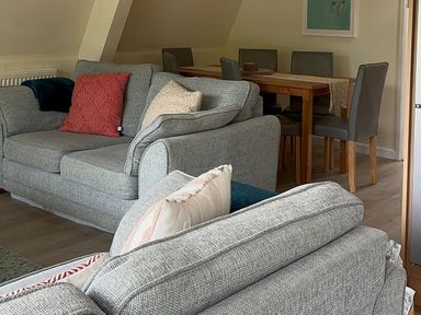 A living room with sofas and a dining area at Lodge 22, Bodmin Holiday Park, Cornwall