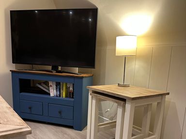 A living room with a television and lamp at Lodge 22, Bodmin Holiday Park, Cornwall in Lanivet