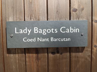 A sign displaying Lady Bagots Cabin at Coed Nant Barcutan