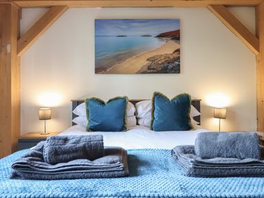 A bedroom with a bed and decorative pillows at Lady Bagots Cabin in Ruthin