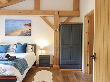 A bedroom with a bed and wardrobe at Lady Bagots Cabin in Ruthin