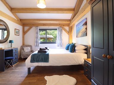 A bedroom with a bed and furniture at Lady Bagots Cabin in Ruthin