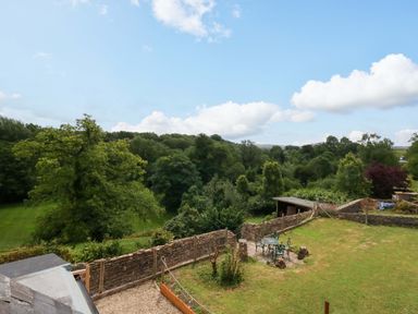 An outdoor view with trees and a garden area at Mallows Byre in Yetminster