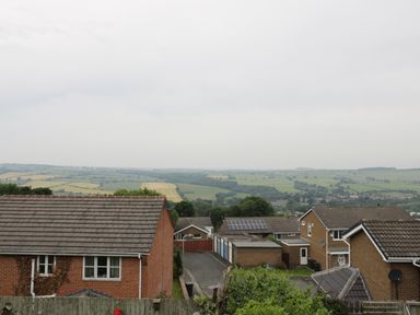 A residential area with houses and garages with fields in the background at The Annex @ Garden House in Prudhoe near Newcastle